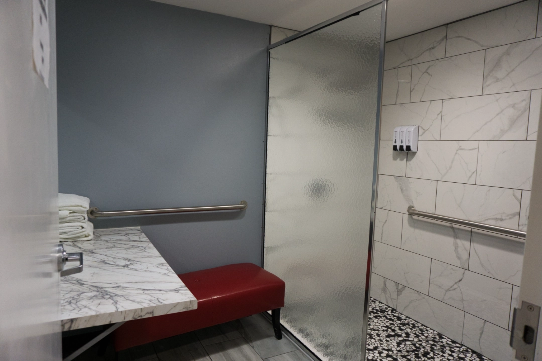 Inside view of the women's shower facility inside 24 Seven Club Fitness